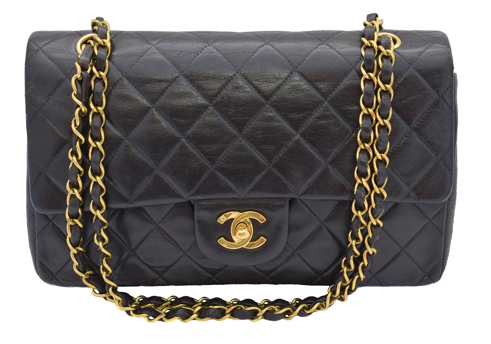 A Chanel Classic Double Flap Handbag, circa 1994 - 1996, the black quilted lambskin leather exterior with gold-tone locking clasp, gold-tone double chain shoulder strap, serial number 3067126. With maker's authenticity card and dust bag.  26x16x7.5cm  Sold for £2,928